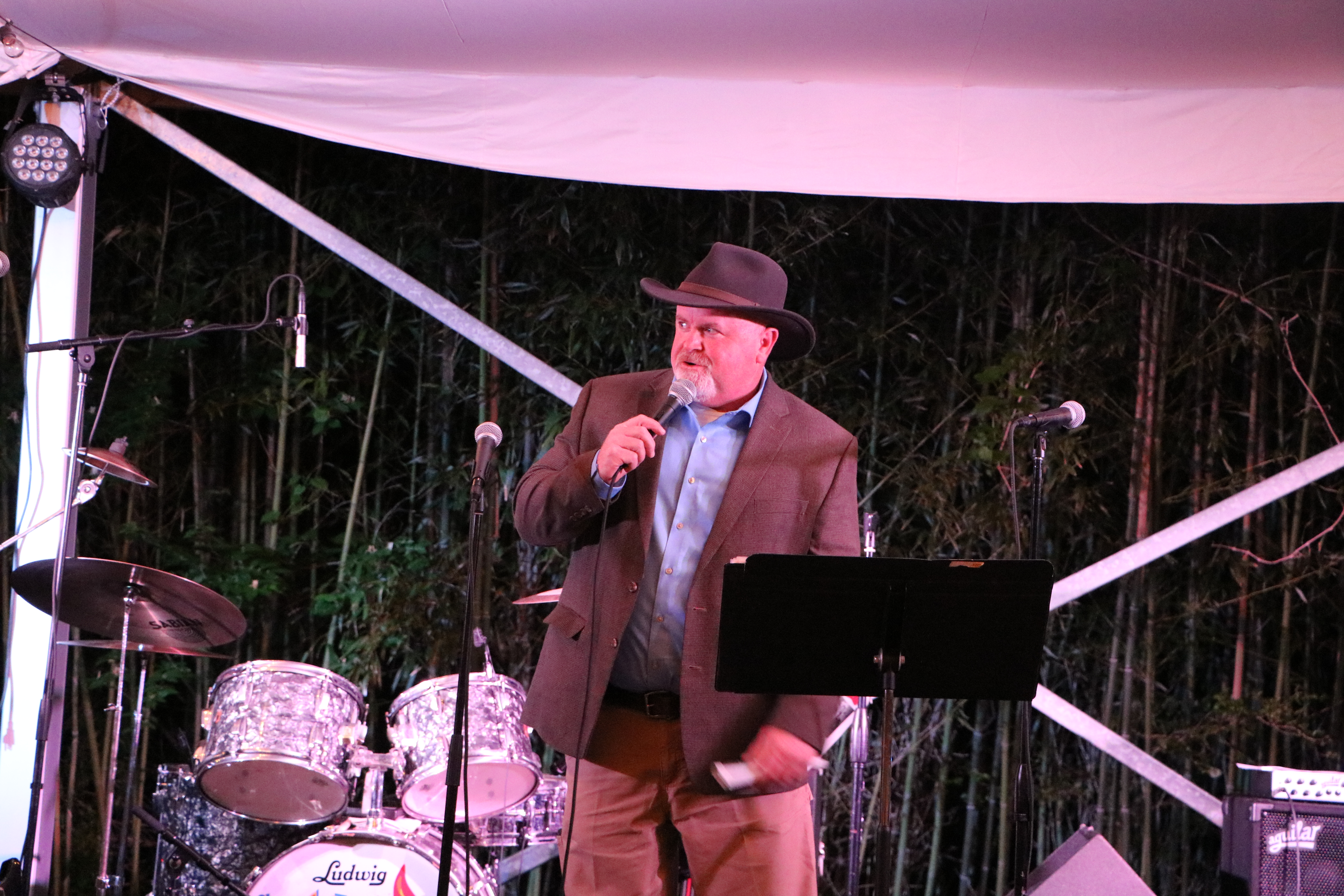 auctioneer on a stage with a microphone