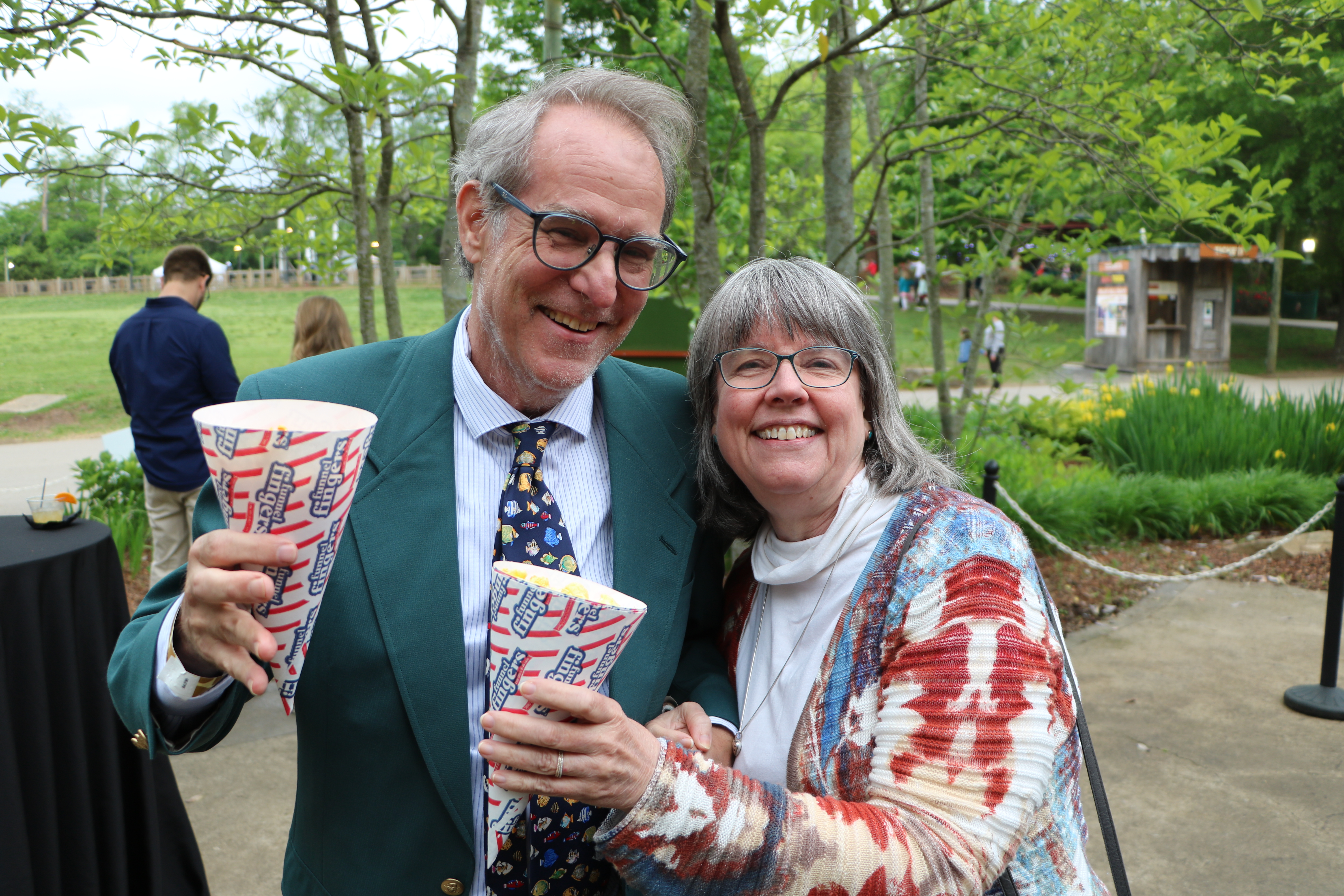 Two people holding popcorn