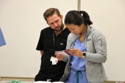 Summer interns Nicholas Davis and Michelle Shin reading a manual during a simulation in the CELA Lab. 